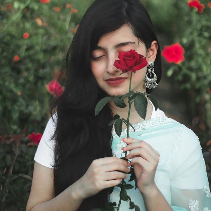 Avery Lin, Lead Design Curator at Summer Cycle Pilot, reviewing corporate floral arrangements